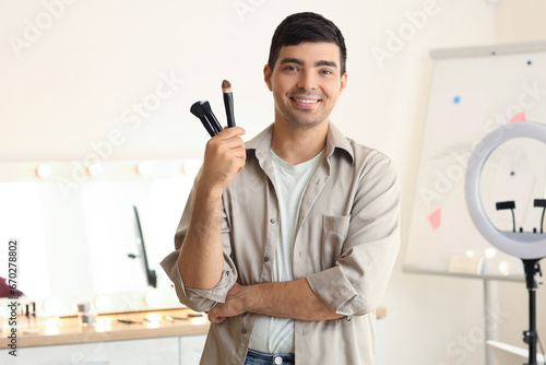Obraz na płótnie Male makeup artist with brushes in dressing room