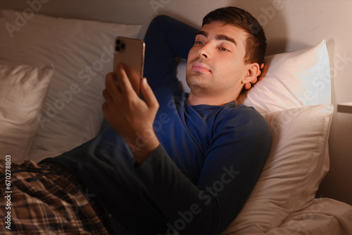 Young man using mobile phon...
