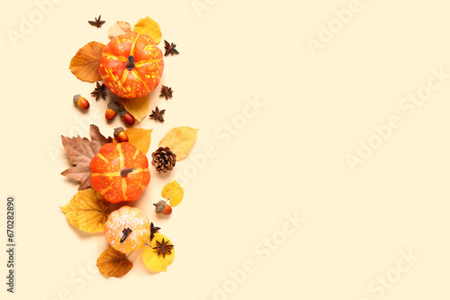 Autumn composition with ripe pumpkins, spices and fallen leaves on light background