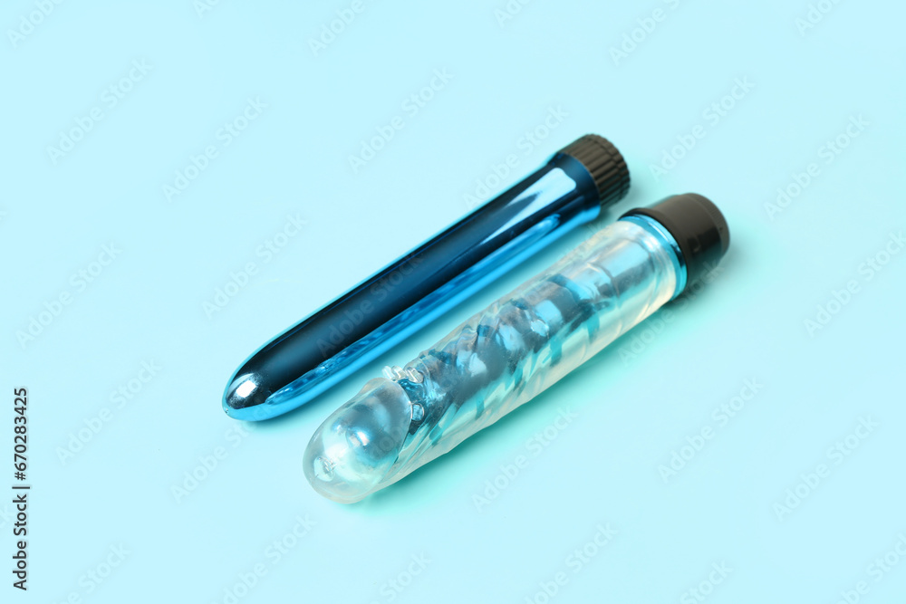 Different vibrators from sex shop on blue background Different vibrators from sex shop on blue background