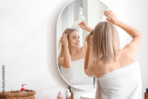 Young blonde woman applying...