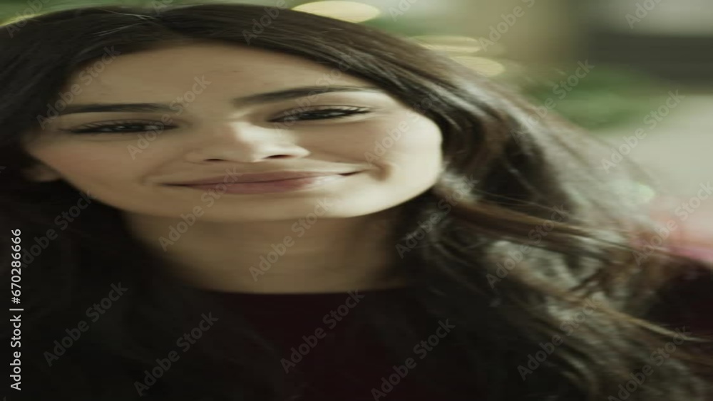 Close up portrait of smiling woman near Christmas tree - vertical video / Orem, Utah, United States Close up portrait of smiling woman near Christmas tree - vertical video / Orem, Utah, United States