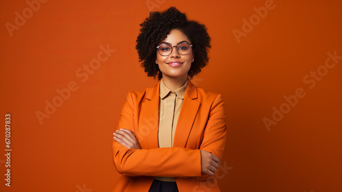 Afro woman young lady in orange business suite stands in front of orange background confident look into camera, AI-Generated, Copy space, solid background, successfull businesswoman  photo