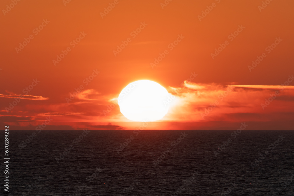 Summer sunset on the sea, photo with a telephoto lens with high magnification.