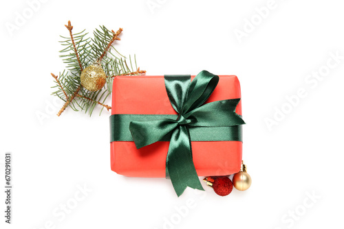 Gift box with Christmas balls and fir branch on white background © Pixel-Shot