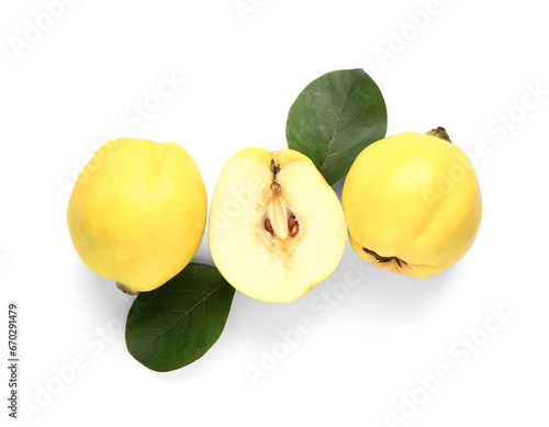 Fresh quinces with green leaves on white background