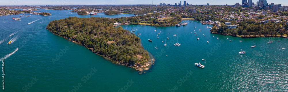 Naklejka premium Panoramic aerial drone view of Berrys Bay, Balls Head Reserve and Waverton Peninsula on the lower North Shore of Sydney, New South Wales, Australia on a sunny day 