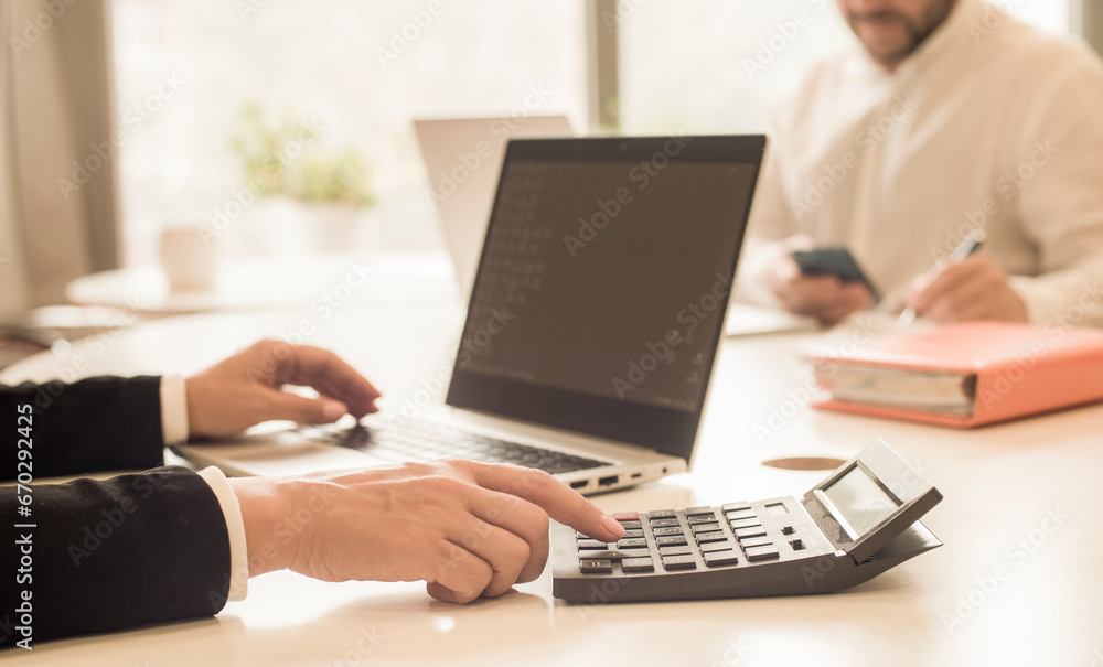 hands with calculator and laptop hands with calculator and laptop