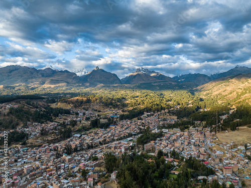 Beautiful aerial view of Andes mountain peaks covered with snow at sunset. City of Huaraz, Peru. © nikwaller