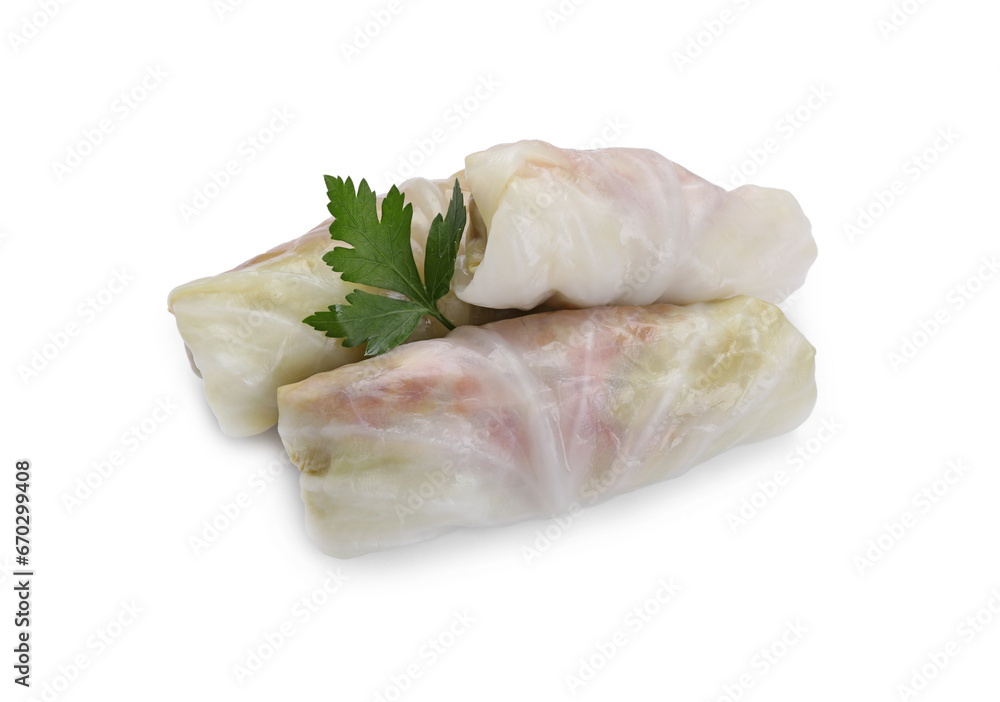 Uncooked stuffed cabbage rolls and parsley isolated on white Uncooked stuffed cabbage rolls and parsley isolated on white