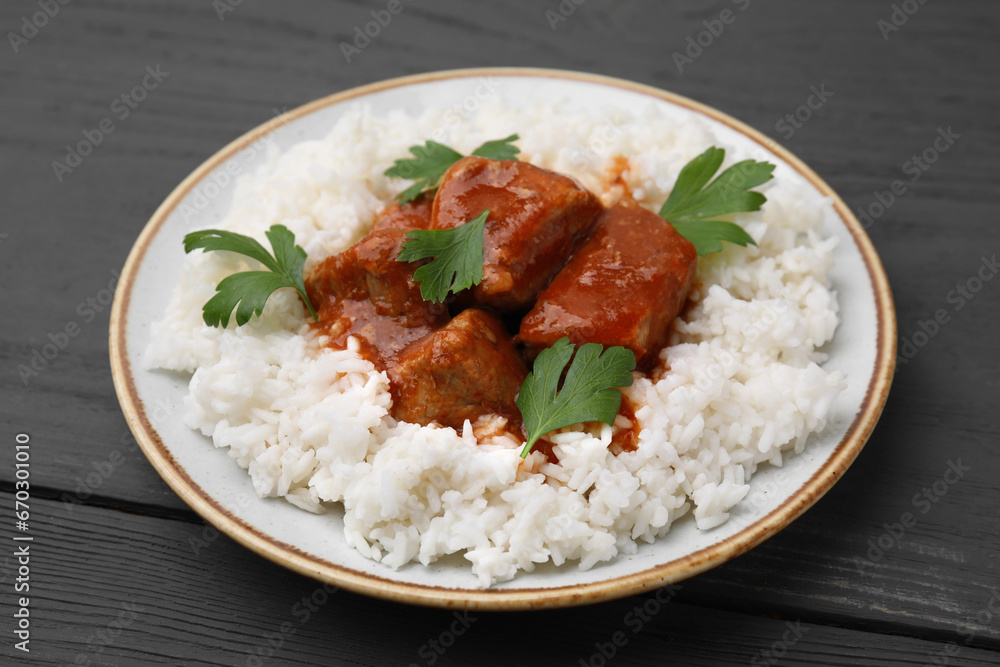 Delicious goulash with rice on grey wooden table, closeup Delicious goulash with rice on grey wooden table, closeup