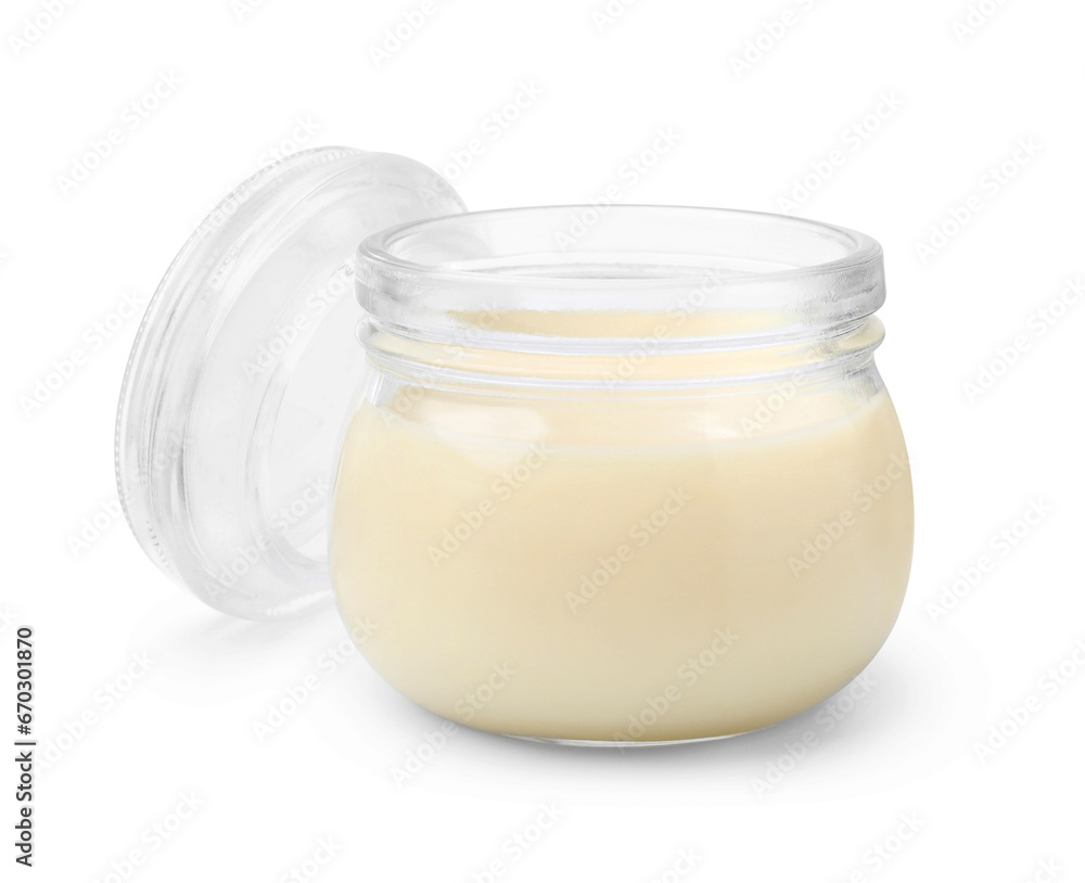 Open jar with condensed milk isolated on white Open jar with condensed milk isolated on white
