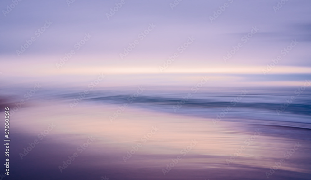 Pink sunset over the sea. Beautiful abstract seascape in light blue and pink colors, motion blur