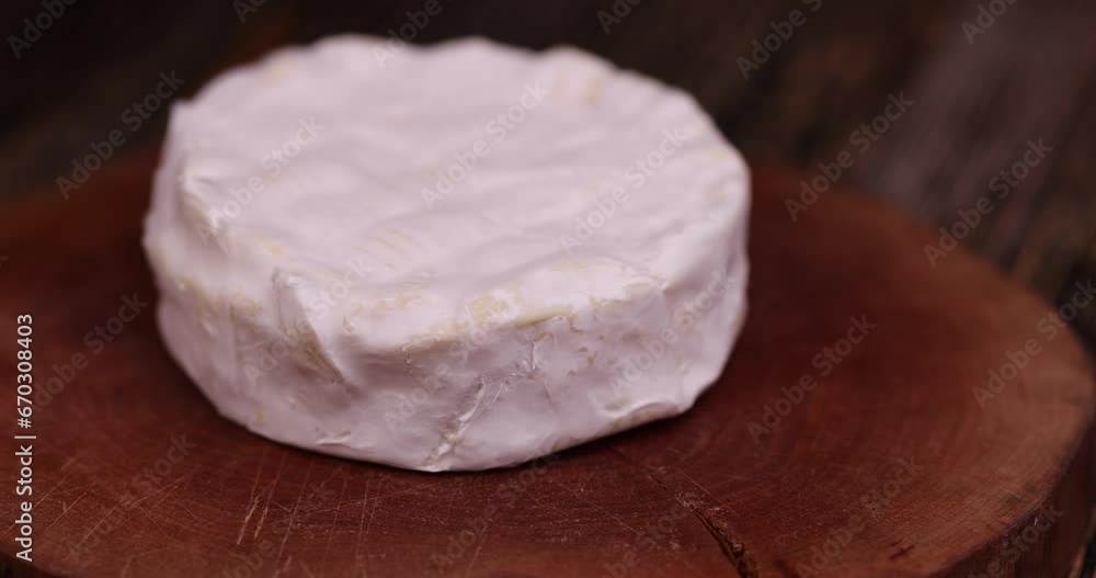 cut soft cream cheese with white mold, delicious white cheese sliced on a board cut soft cream cheese with white mold, delicious white cheese sliced on a board
