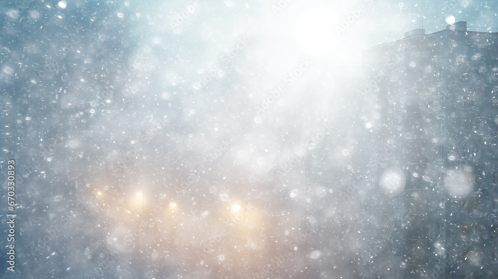 Obraz premium blizzard in the city, abstract blurred light white urban background, snowfall on the background of apartment buildings in the city, silhouette, copy space