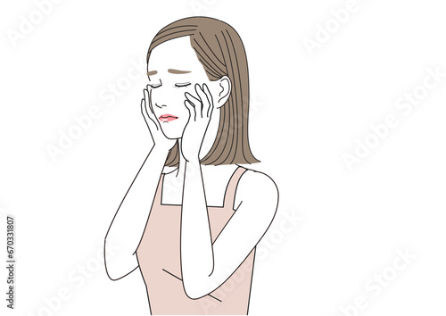 手を顔にあて、目を閉じて悲しんでいる女性