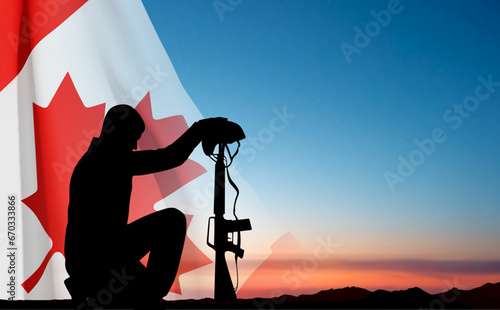 Silhouette of soldier kneeling down with Canada flag against the sunset. Greeting card for Poppy Day, Remembrance Day. EPS10 vector photo