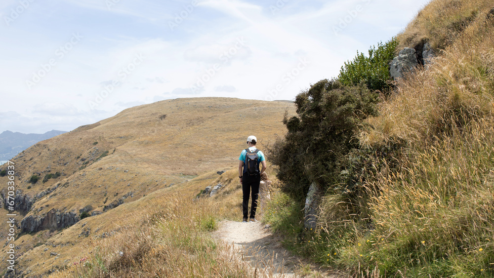 A family hiking along the ocean in New Zealand. The concept of local travel. 