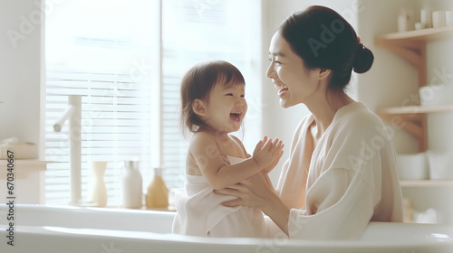 A mother takes a bath with her little daughter, Asian family and hygiene.