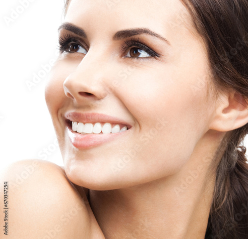 Face portrait photo of beautiful young happy smiling woman, isolated against white background. Studio image of cheerful smile brunette beauty girl. Dental care concept.