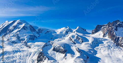 The mountain view of alpine as snow-capped mount peaks in Winter mountains, panorama scene