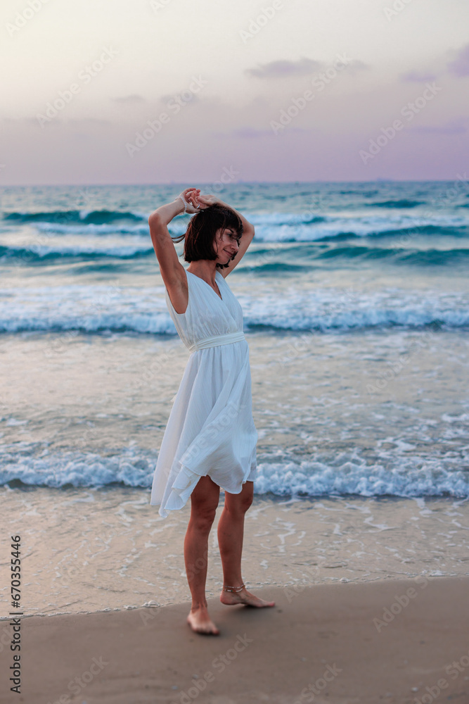 Happy traveler girl in a white summer dress enjoying a tropical paradise beach with turquoise sea. Happy traveler girl in a white summer dress enjoying a tropical paradise beach with turquoise sea.