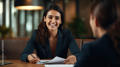 Indian insurance sales woman or investing advisor explaining the plan to her client.