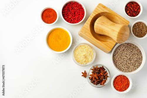 Wooden mortar with spices on white background