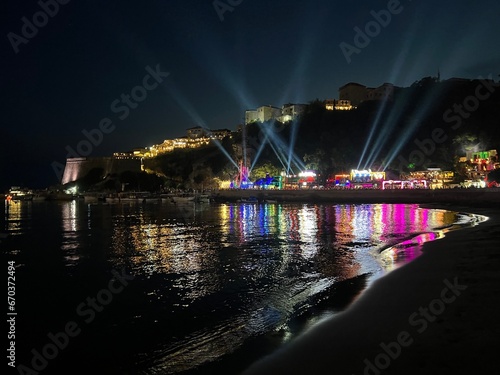 Night sea beach, view on illuminated old town Ulcinj in Montenegro