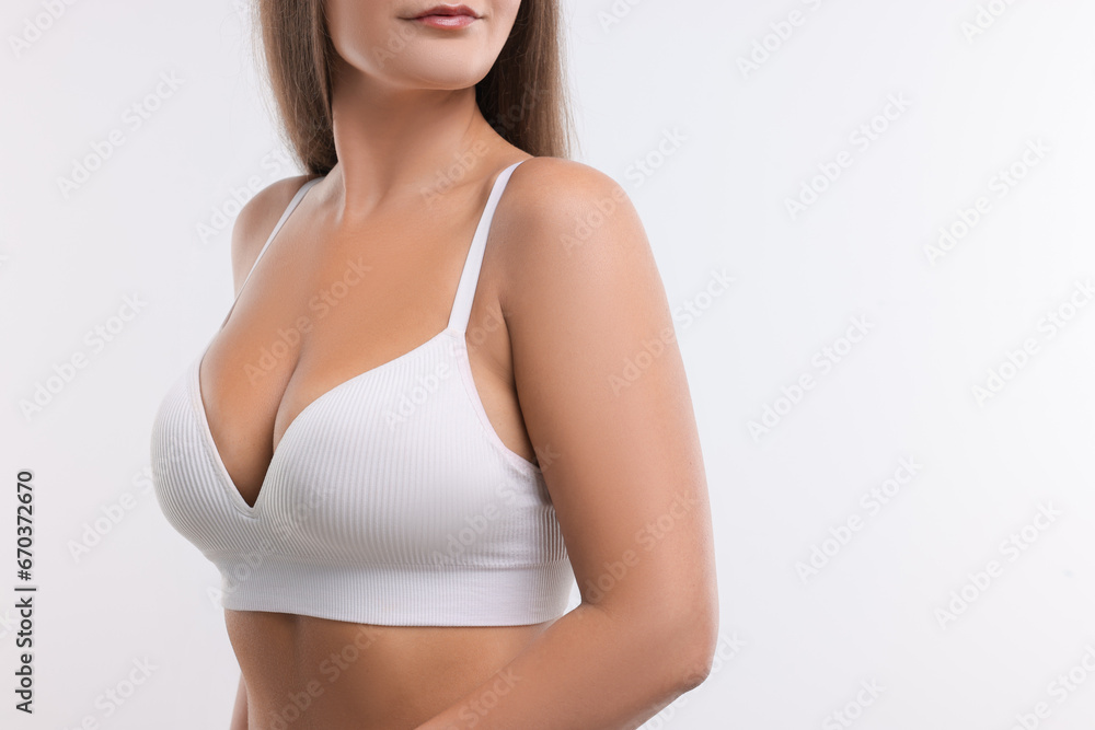 Fototapeta premium Woman with beautiful breast on white background, closeup. Space for text