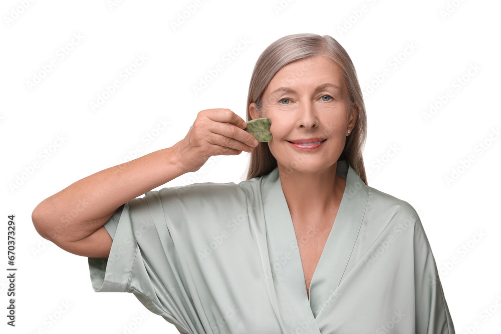 Woman massaging her face with jade gua sha tool isolated on white Woman massaging her face with jade gua sha tool isolated on white