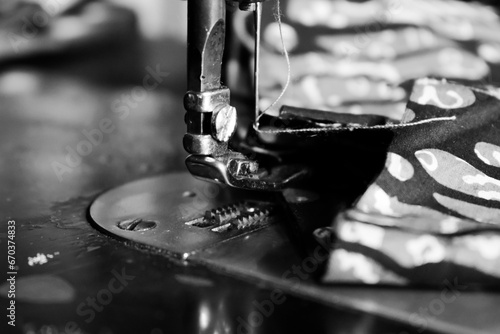 Vintage Black and White, Close up Sewing machine sews batik indonesian fabric into cloth, vintage black and white concept
