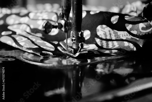 Vintage Black and White Close up Senior Female Tailor Sewing batik indonesian fabric into cloth, elder senior and vintage black and white concept