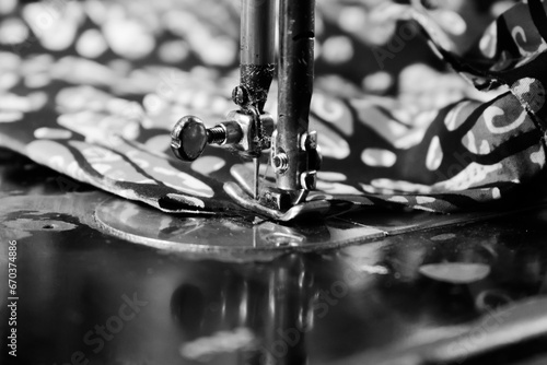 Vintage Black and White Close up Senior Female Tailor Sewing batik indonesian fabric into cloth, elder senior and vintage black and white concept
