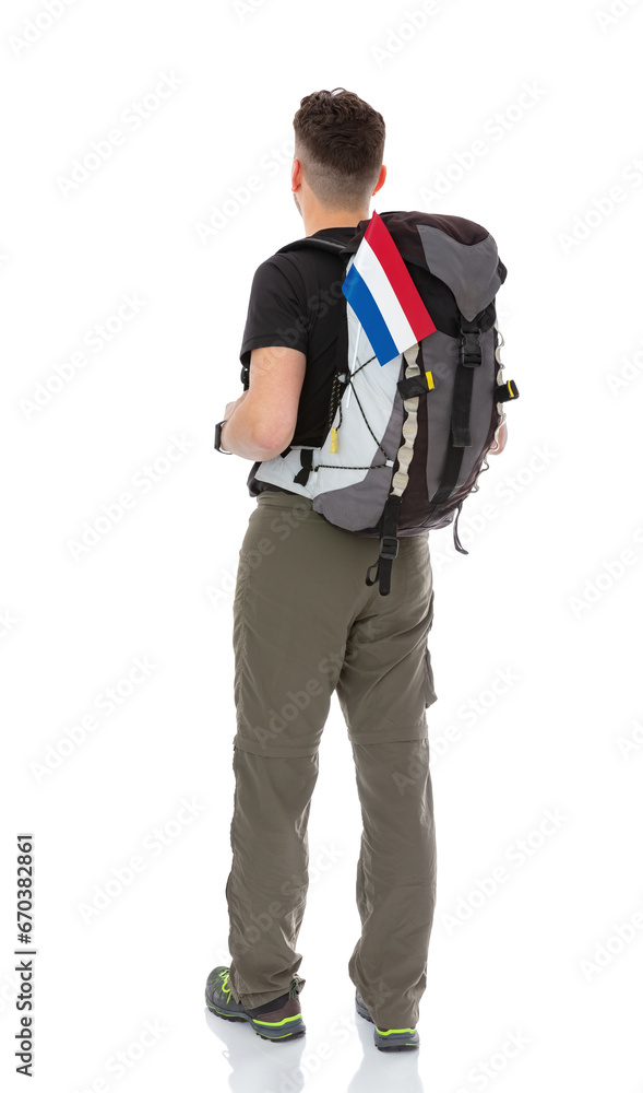 Back view full-length portrait of trekker with a backpack and flag of Netherlands isolated on white background. Thirty years old man in black T-shirt posing in studio. Back view full-length portrait of trekker with a backpack and flag of Netherlands isolated on white background. Thirty years old man in black T-shirt posing in studio.
