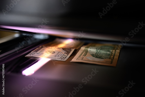 Using a copy machine to print forgery currency.  photo