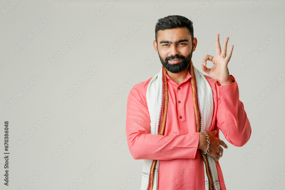 Young indian farmer giving expression on white background. - obrazy, fototapety, plakaty 