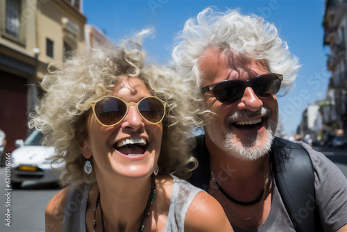 mature couple with white hair and sunglasses smiling