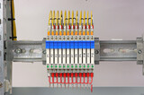 Ultra-thin electromechanical relay for connecting electrical loads in an electrical switchboard on a din rail.