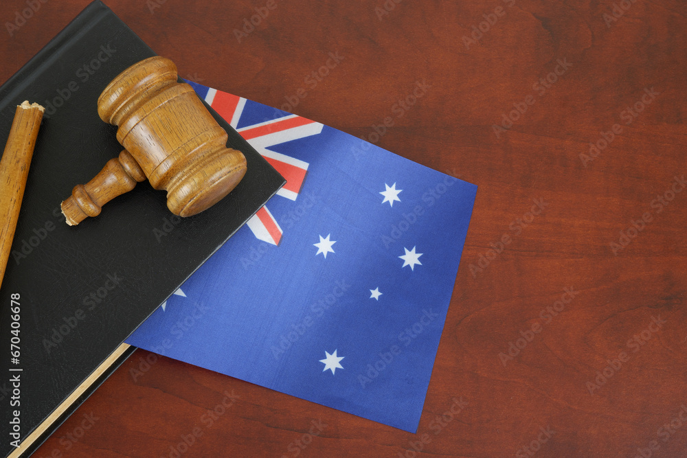 Broken gavel and legal book with flag of Australia. Copy space for text.