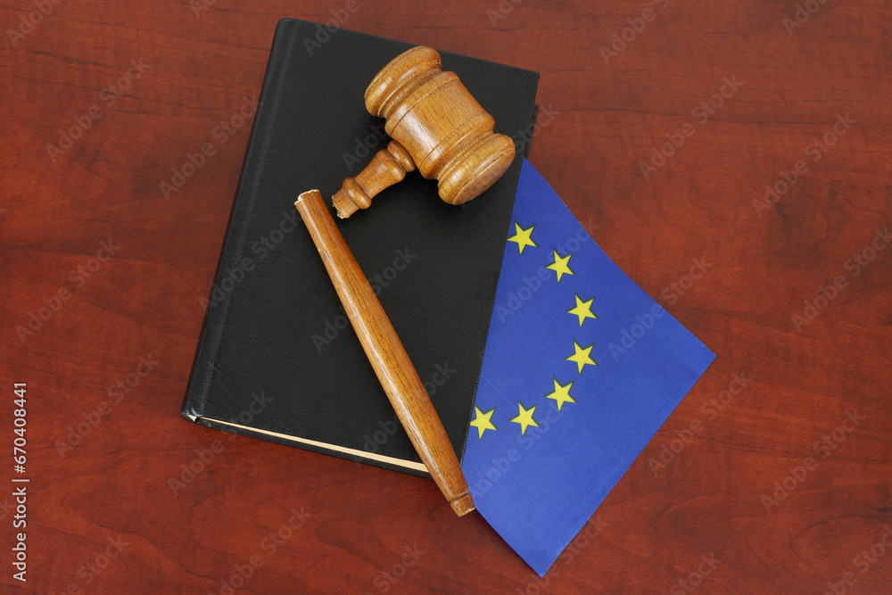 Broken judge gavel and legal book with flag of European Union. Problems in EU laws concept.