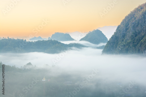 Aerial view of flowing fog on mountain tropical rainforest in the morning