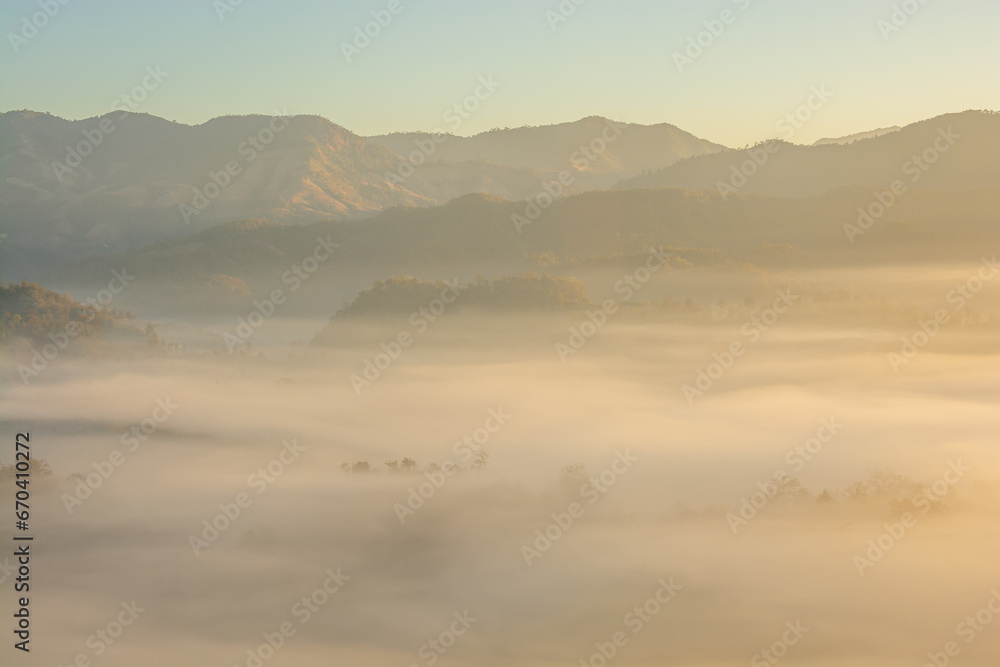 Aerial view of flowing fog  on mountain tropical rainforest in the morning