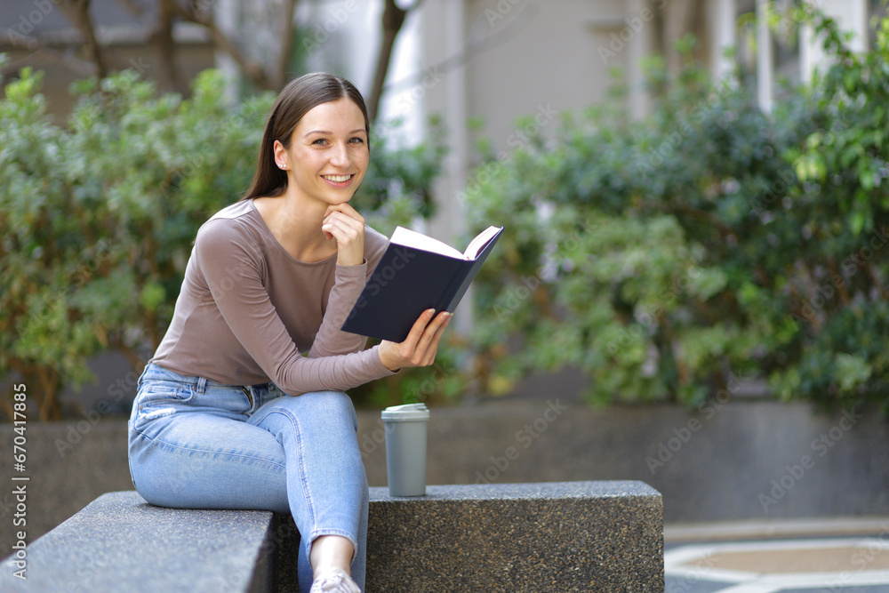 Fototapeta premium Female university students reading textbooks preparing for exams.