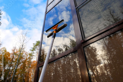Washing windows with a window brush. Window cleaning brush for windows.