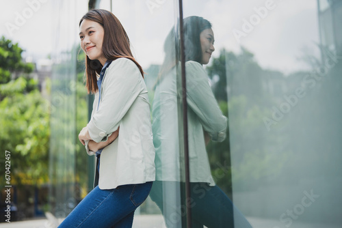 Photo of young Asian businesswoman outdoor