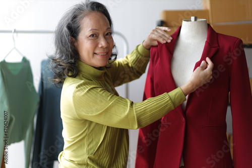 Senior female designer works as a fashion designer and owns a small business, a successful online clothing store.