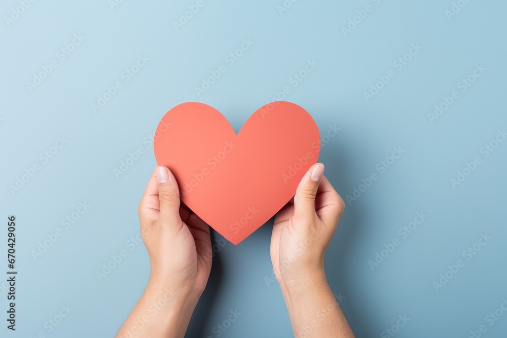 Top view of woman hands holding blank paper greeting or invitation card over blue background with heart shape. Christmas, Valentine, New Year, winter holidays concept Top view of woman hands holding blank paper greeting or invitation card over blue background with heart shape. Christmas, Valentine, New Year, winter holidays concept