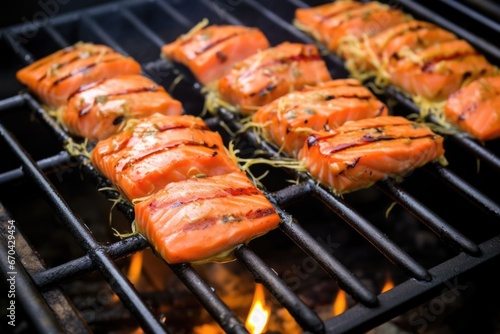 hot grill with salmon fillets basted in apple cider bbq sauce