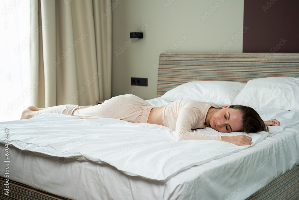 Tired young woman falls on the bed. Tired young woman falls on the bed.